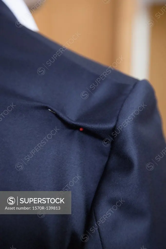 Detail of a pin in the shoulder of a suit jacket