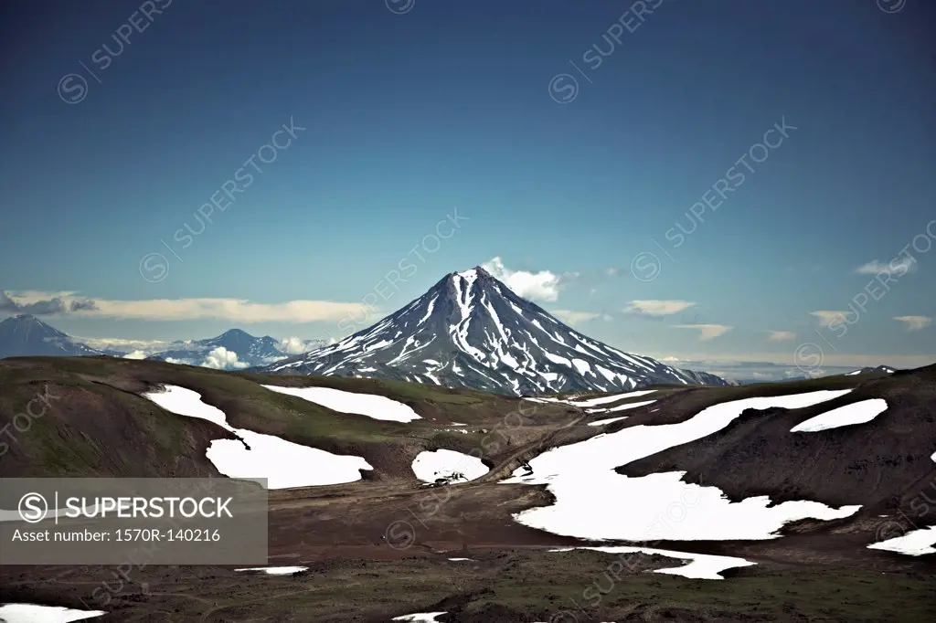 Patches of snow in a valley in front of Koryaksky Volcano, Russia