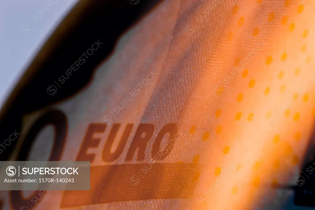 A twenty euro banknote on fire, extreme close up