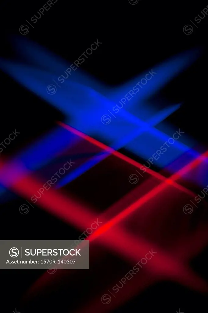 Blue and red lights crisscrossing against a black background
