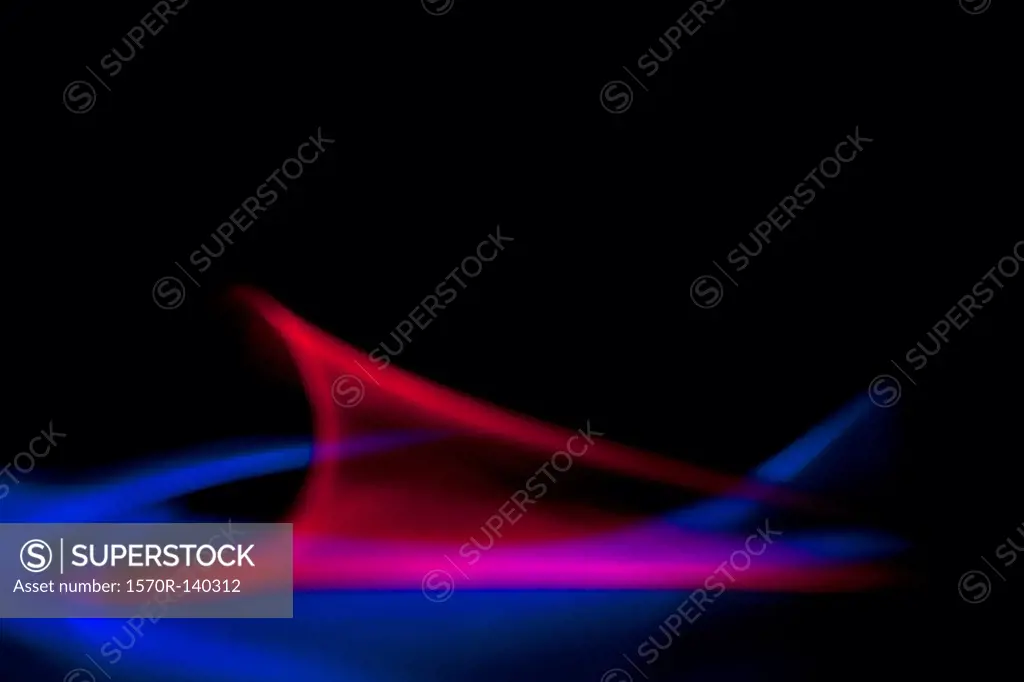 Abstract patterns of blue and red light on a black background