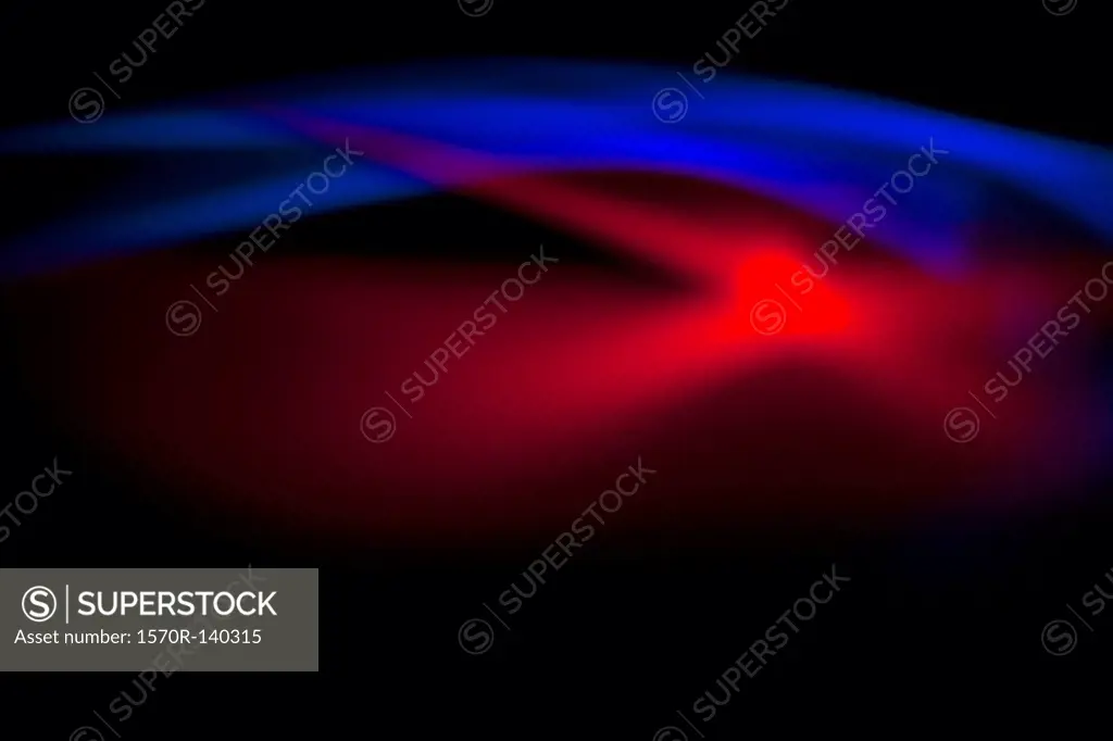 Abstract patterns of blue and red light on a black background