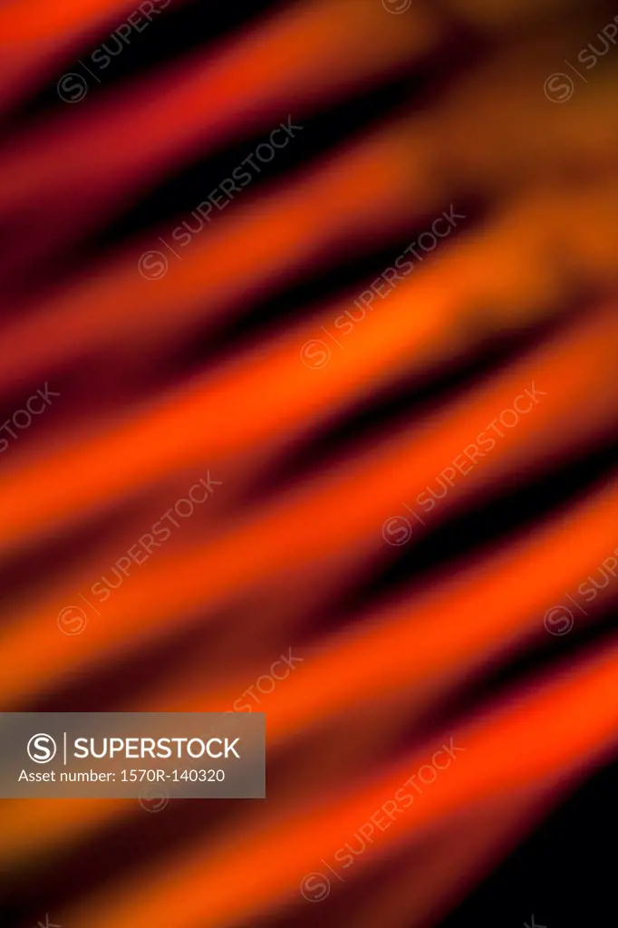 Orange and red slanted lines created by a light effect, close-up, defocused