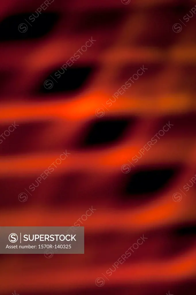 Abstract pattern of crisscrossing orange and red light beams