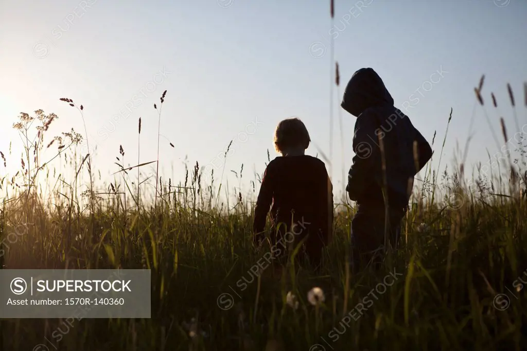 Two boys standing in a field