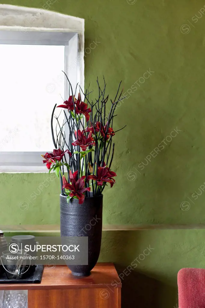 A vase of flowers on a sideboard