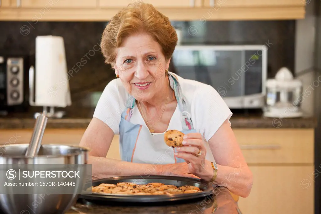 A senior woman with freshly baked cookies