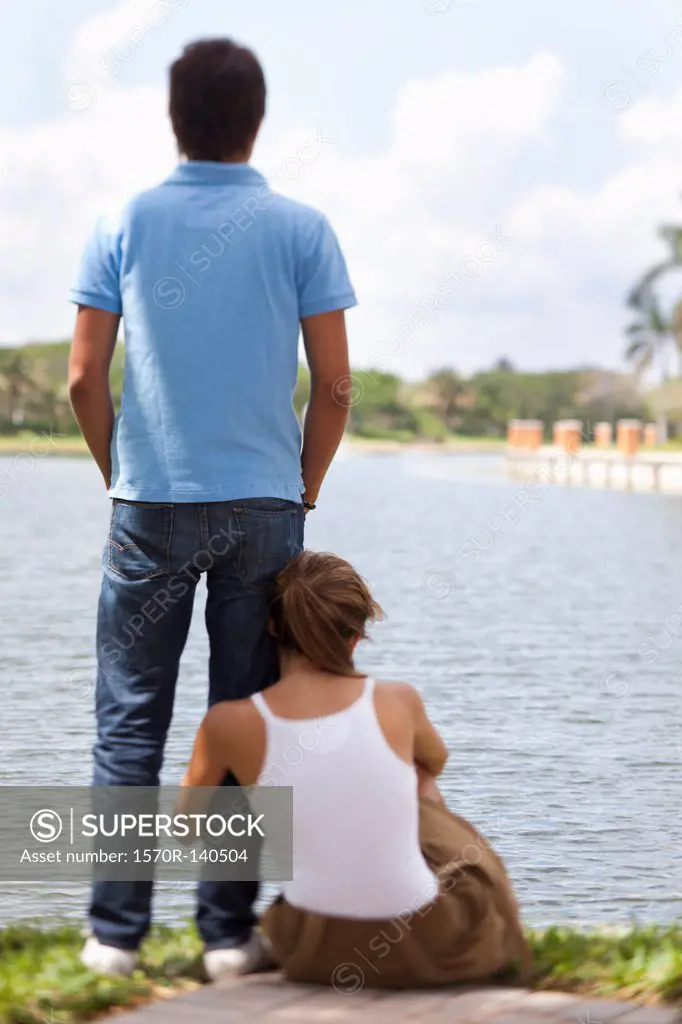 A young couple relaxing by a lake