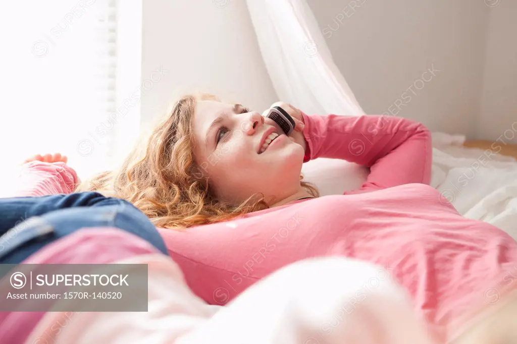 Girls on bed on the phone