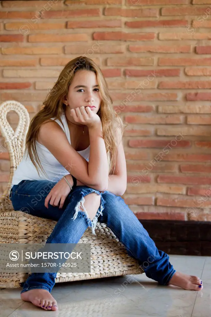 Bored girl on wicker chair