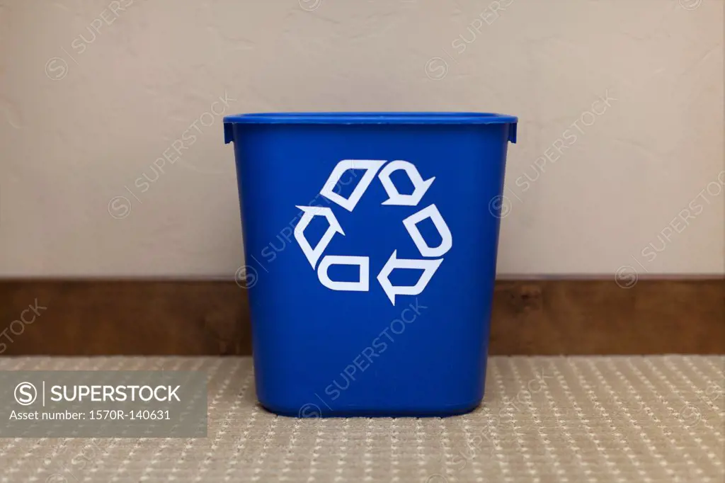 A blue recycling bin