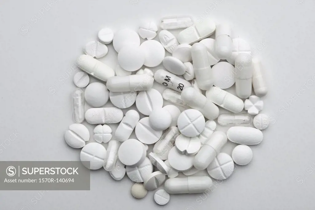 A heap of various white pills and capsules