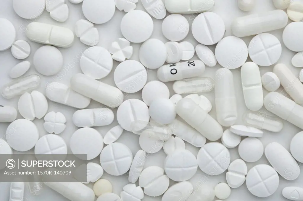Heap of various white pills and capsules, close-up