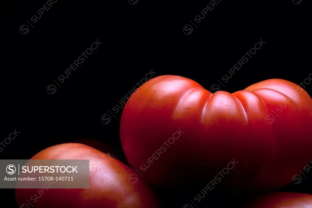 A stack of ripe tomatoes, close-up