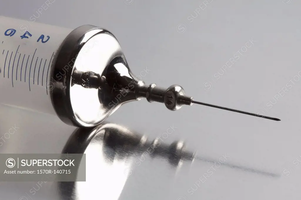 Close-up of metal and plastic syringe