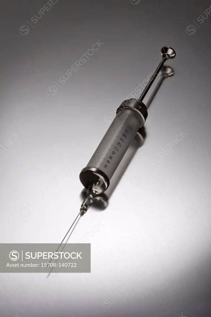 A metal and plastic syringe