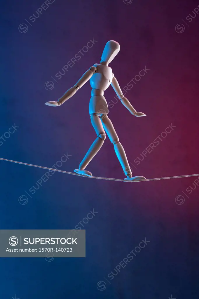 An artist's figure walking a tightrope