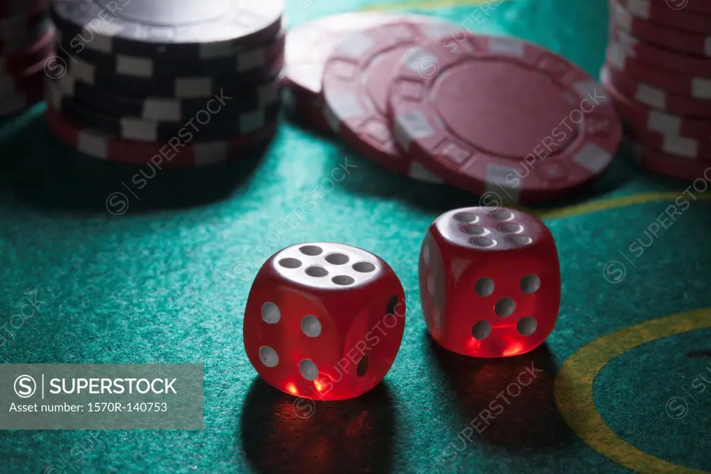 Two rolled sixes on a craps table, gambling chips in the background