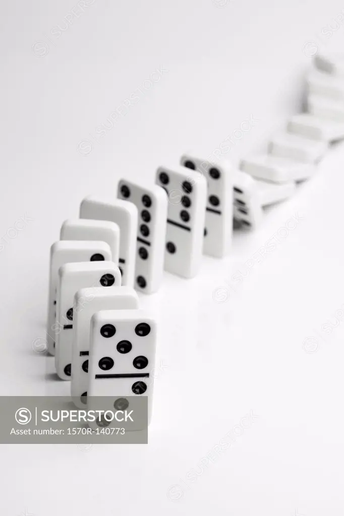 Dominoes falling over in a chain reaction