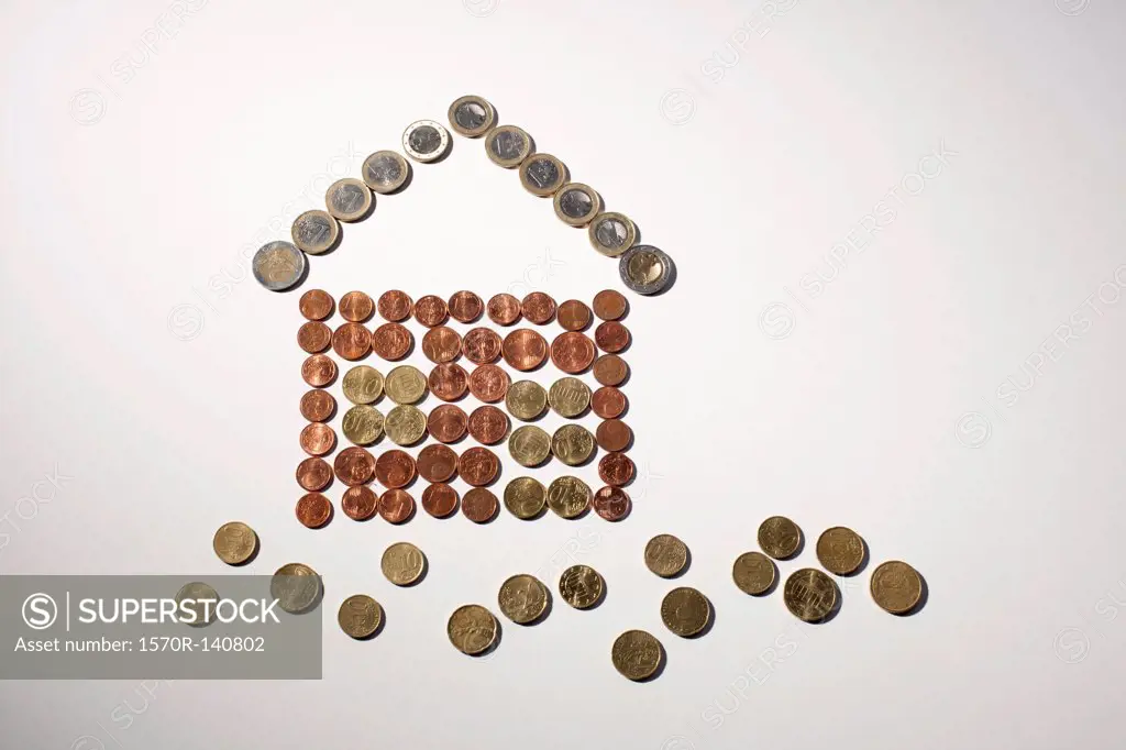European Union coins arranged into the shape of house and grass