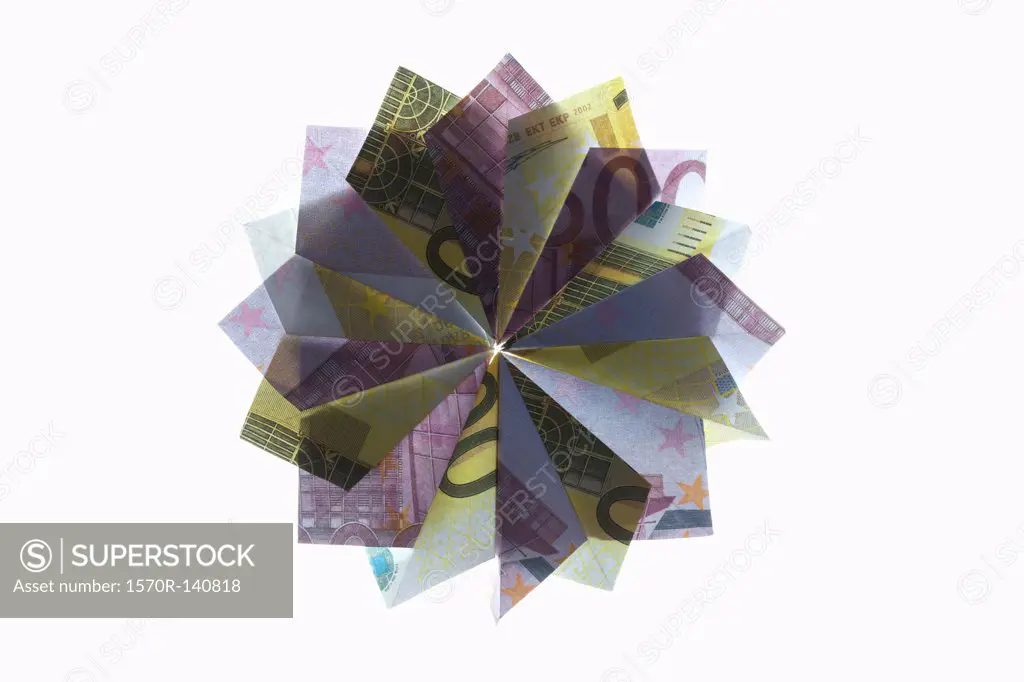 Five hundred Euro bills and two hundred Euro bills folded into a pinwheel shape