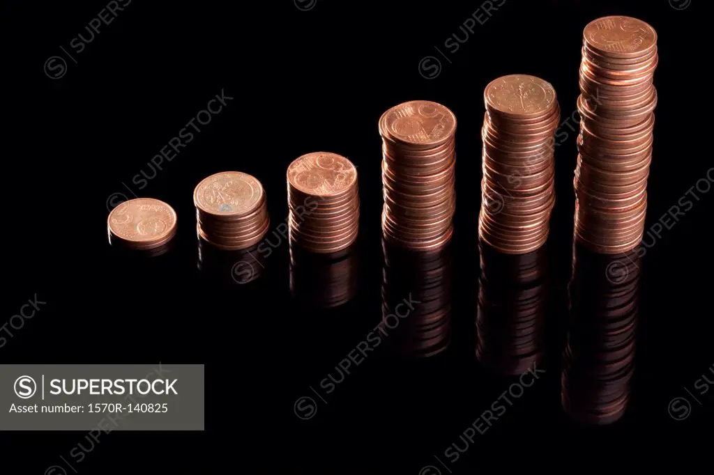 Rows of stacks of five cent Euro coins increasing in size