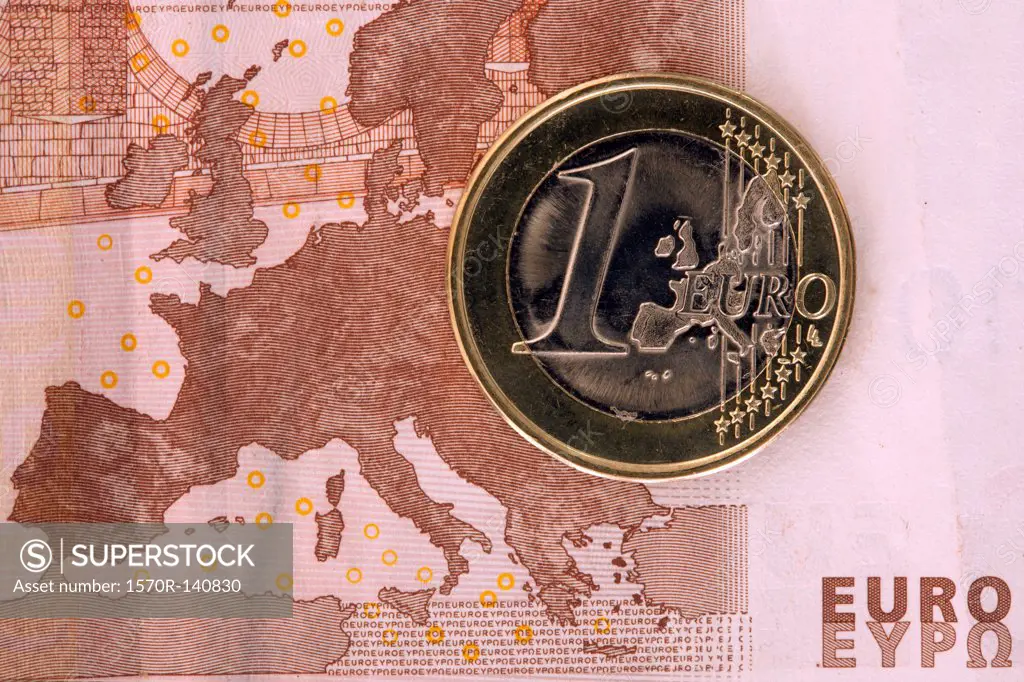 Detail of a ten Euro banknote with a one Euro coin on top of it