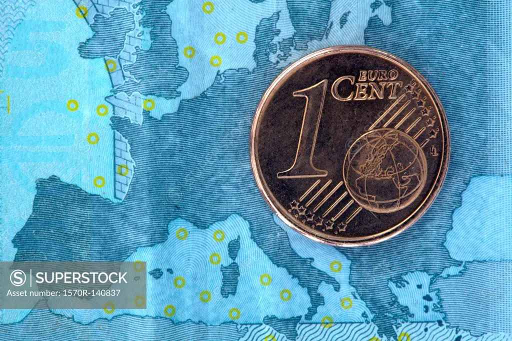 Detail of a five Euro banknote with a one cent Euro coin on top of it