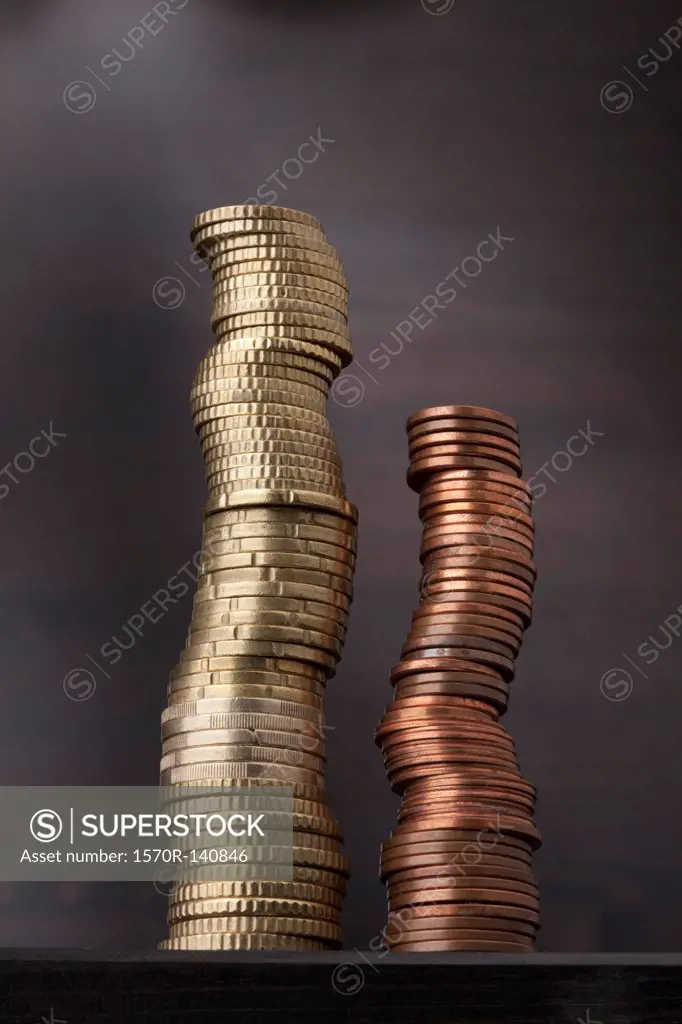A stack of gold Euro coins next to a stack of copper Euro coins