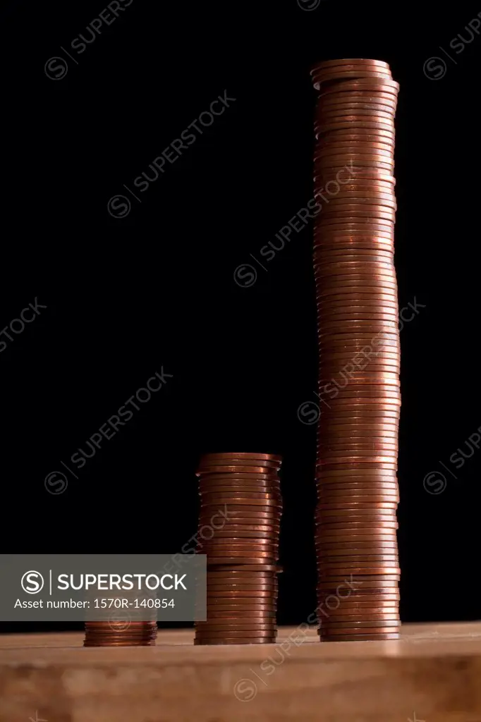 Three rows of stacks of copper coins increasing in size