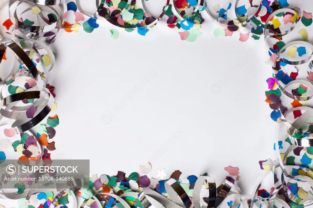 Confetti and streamers arranged into a square shaped frame