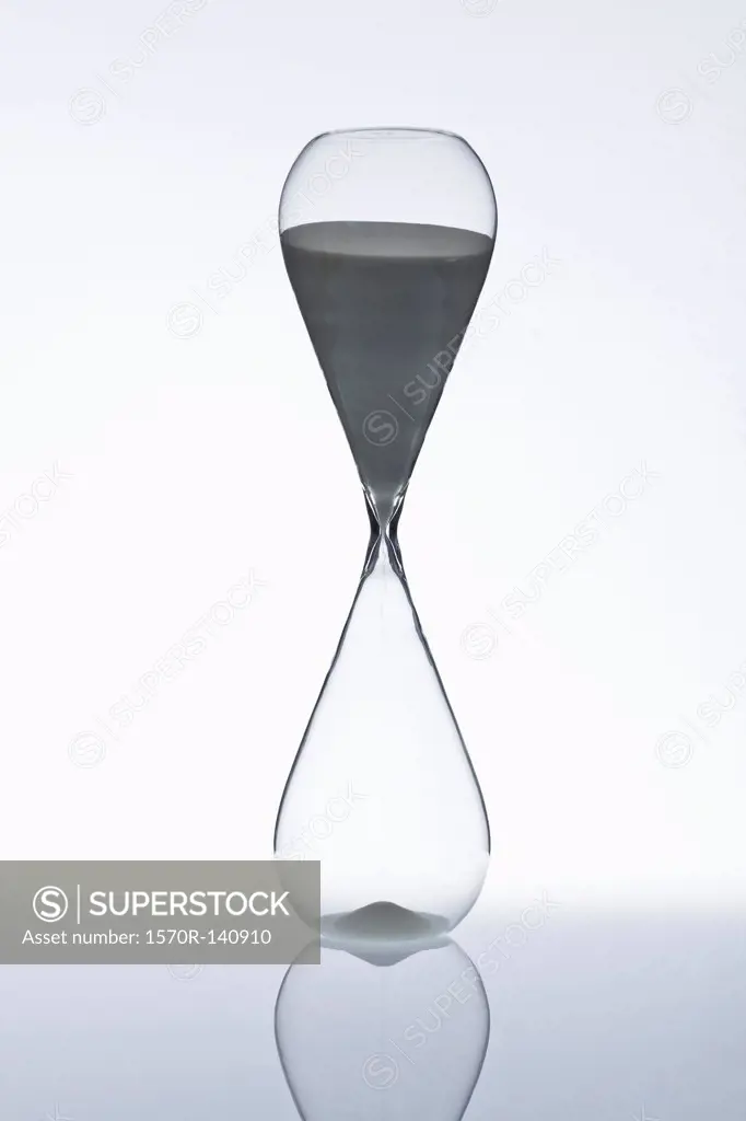 Sand beginning to run through an hourglass