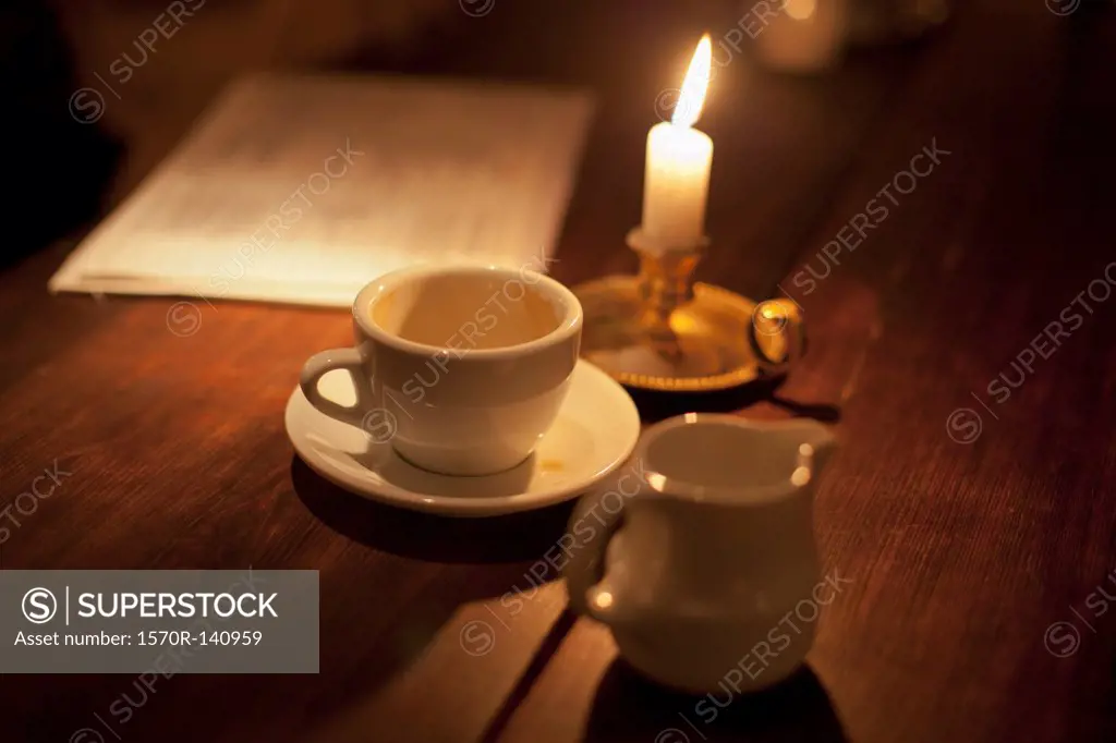 Empty cup of coffee by the candle light