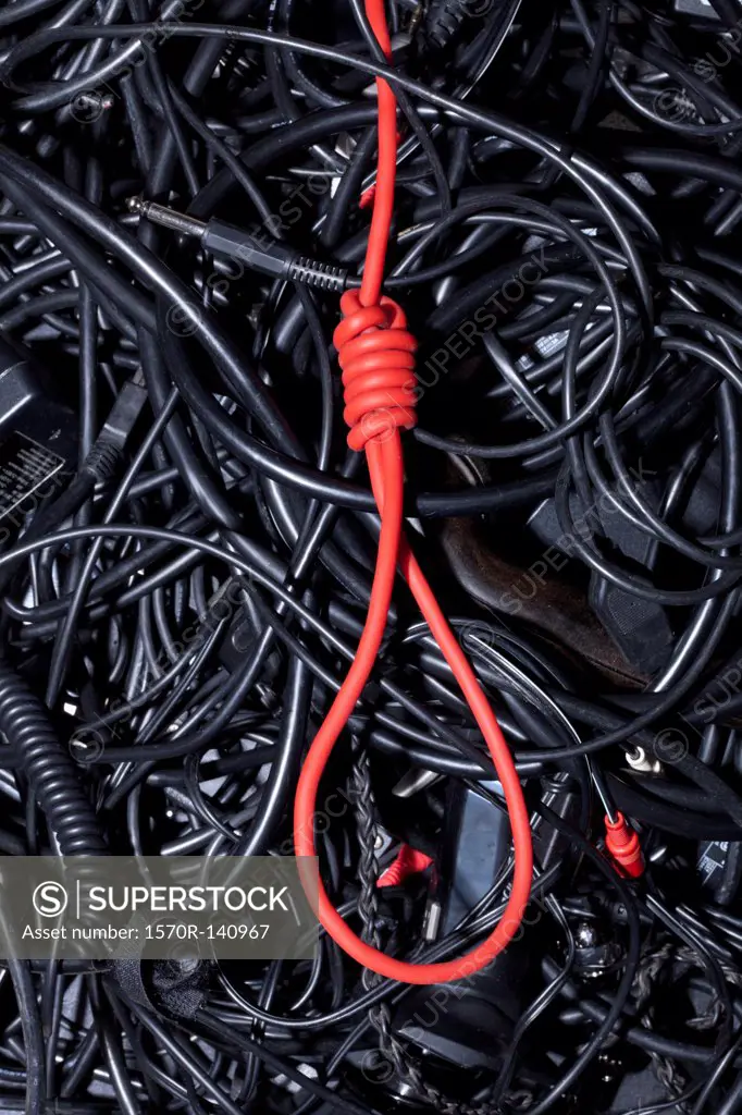 A red cord tied into a noose amongst tangled black cables and cords