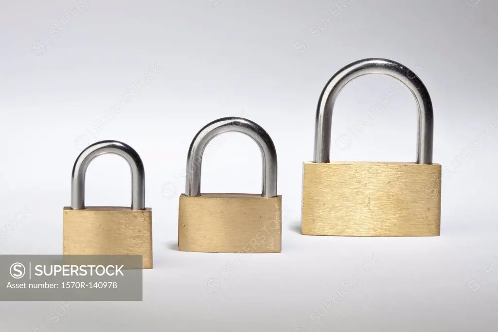 Three different sized padlocks in a row