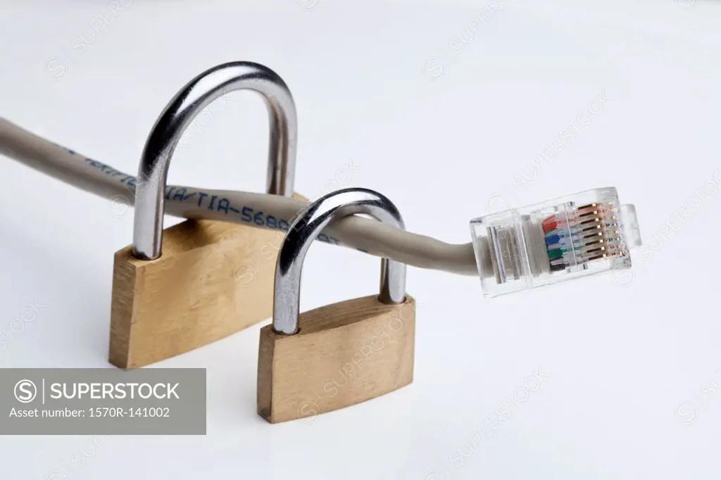 Two padlocks around an Ethernet cable