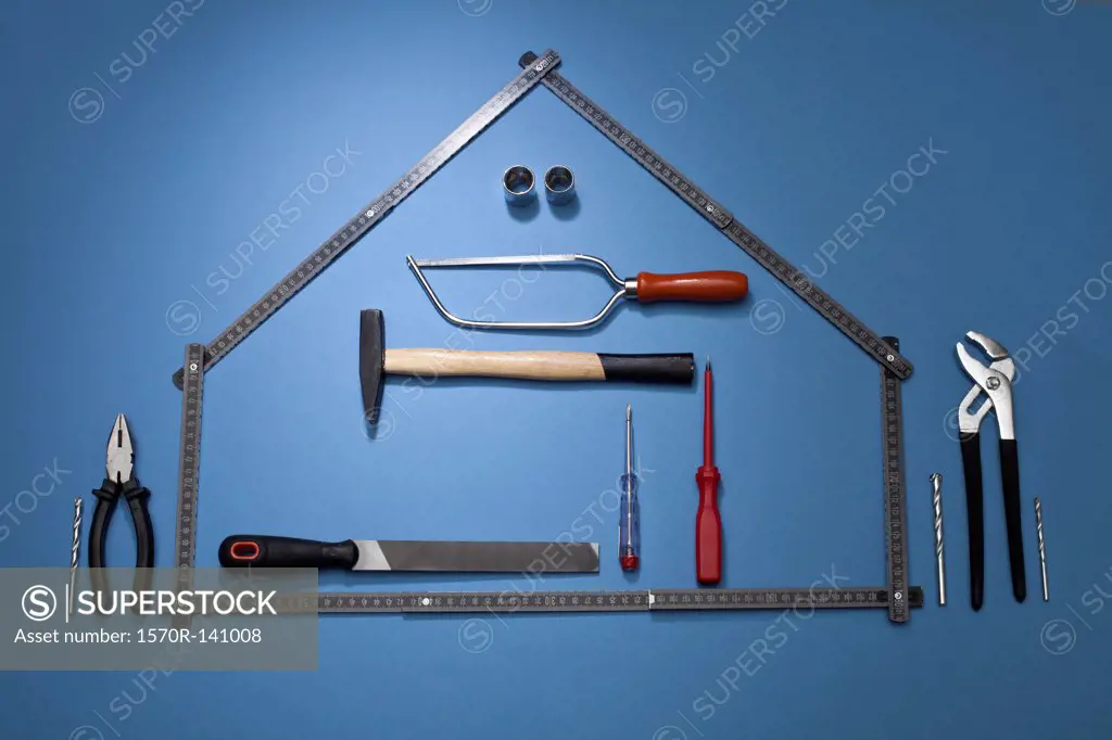 A folding ruler arranged to look like a house with various work tools