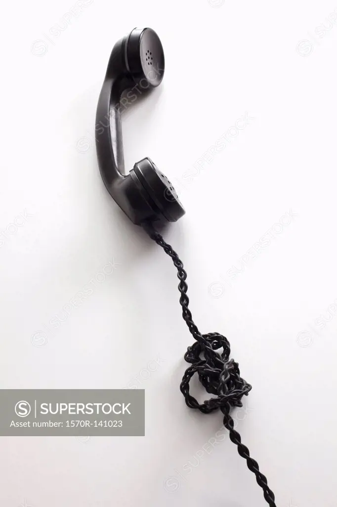 An old-fashioned telephone cord tangled in a knot