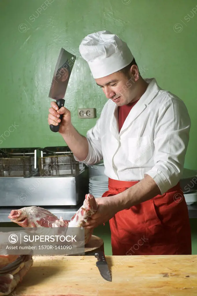 A butcher chopping meat with a cleaver