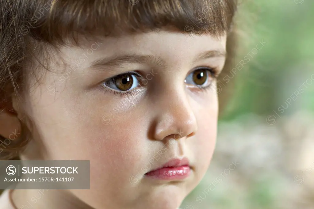 Close-up of a young girl staring