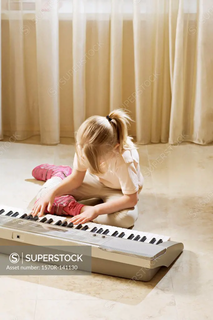 A girl playing an electronic keyboard