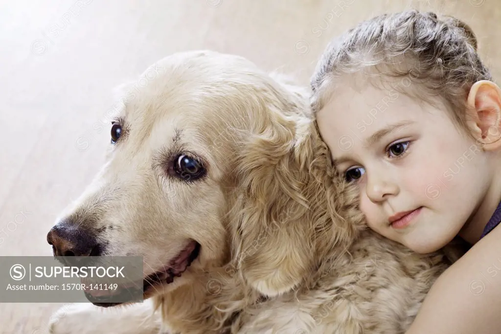 Close-up of a young girl hugging a dog