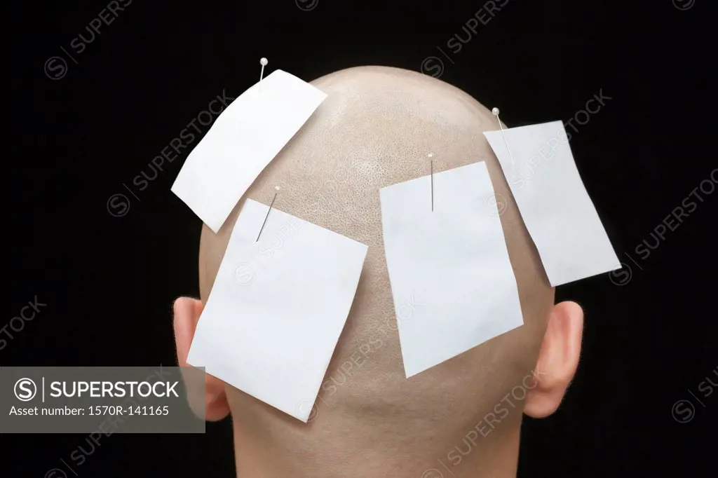 Blank notes pinned to the head of a man