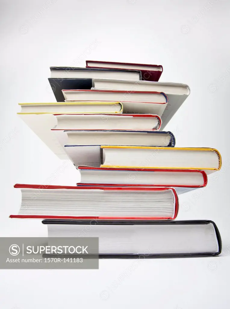 A stack of various hardcover books, diminishing perspective