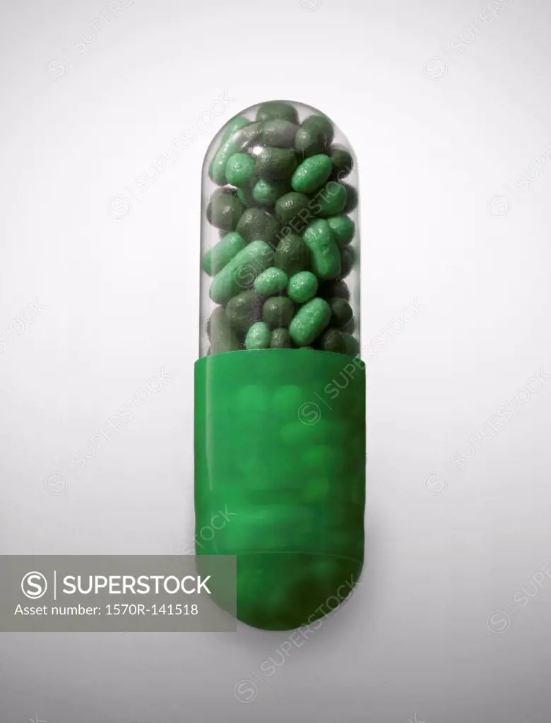 A vibrant green capsule pill, close-up