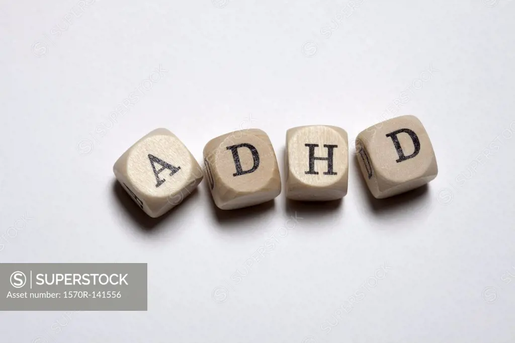 Lettered cubes arranged to spell the abbreviation ADHD
