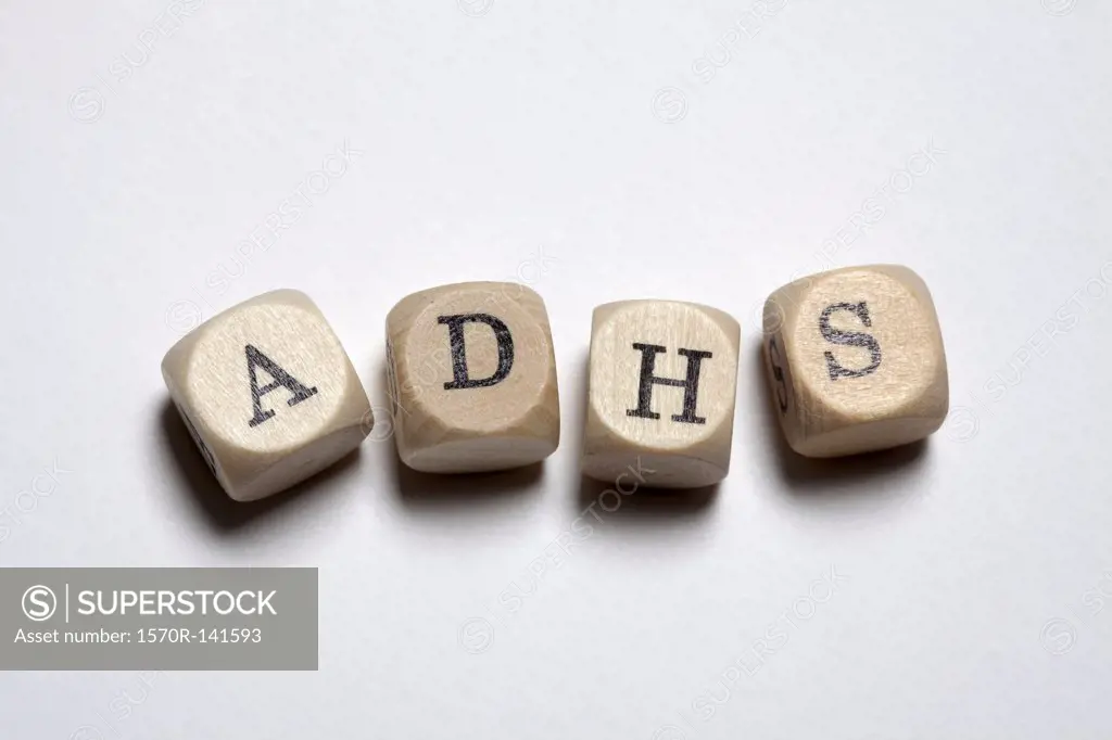 Lettered cubes spelling ADHS, the German acronym for Attention Deficit Hyperactivity Disorder
