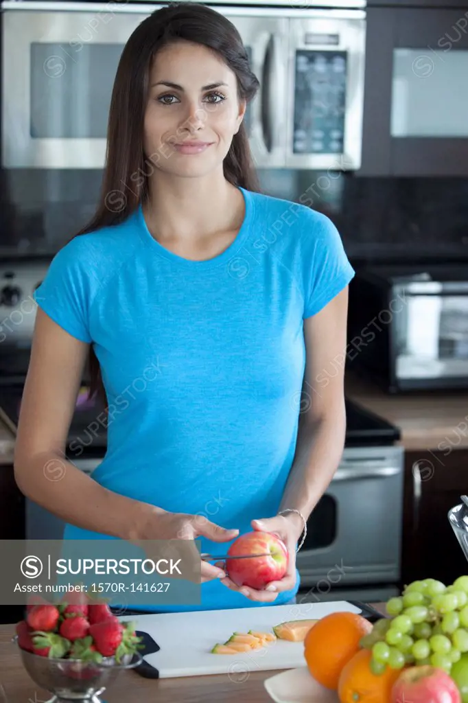 Woman preparing fruit in kitchen
