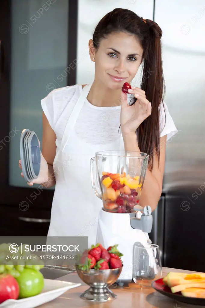 Woman with fruit blender