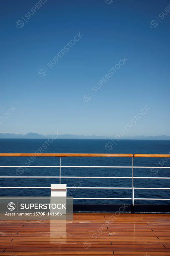 Sun shining on the boat deck of a passenger ship, Canadian coastline in background